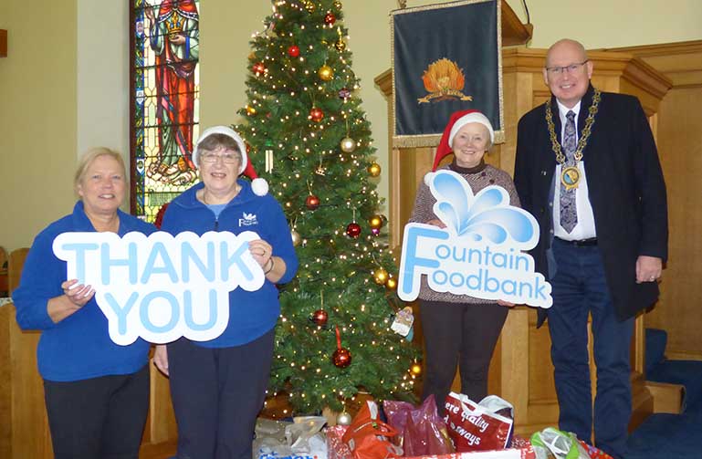 Newry Mourne and Down Council Chairperson, Councillor Michael Savage with (from left to right) Fountain Foodbank Downpatrick Volunteers Jill Reid, Sandra Shields and Dorothy Corkin.