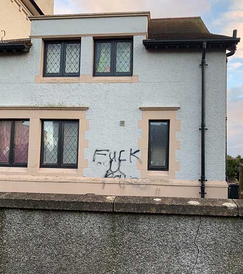 Graffiti on a home in Downpatrick has been called a hate crime by local police. 