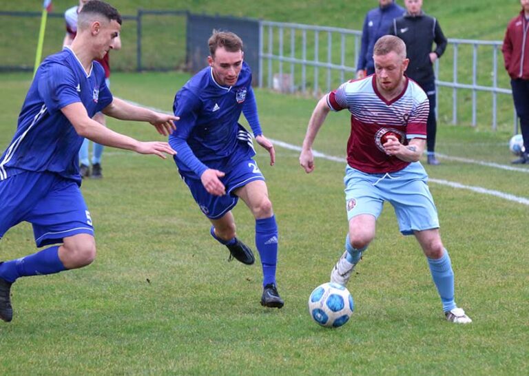 Nathan Jones attacking for Ballynahinch as Foundry's Aaron Knowles and Cameron Croft close in. (Photo by Cyril McKinney),