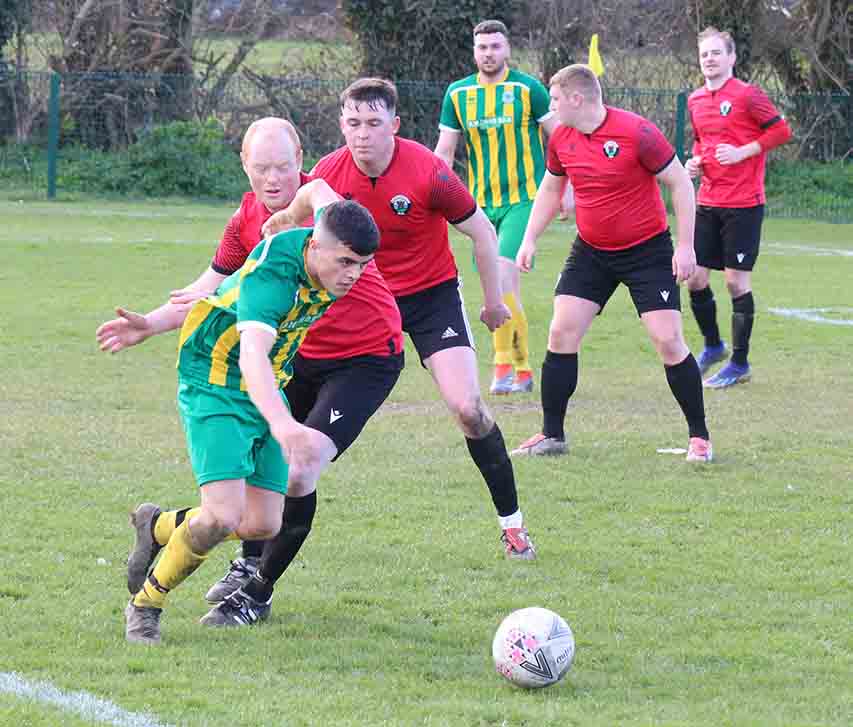Killouigh's Daire McLaughlin pushes for the ball as Ardglass defender Malachy Crangle closes in. (Photos by Cyril McKinney).