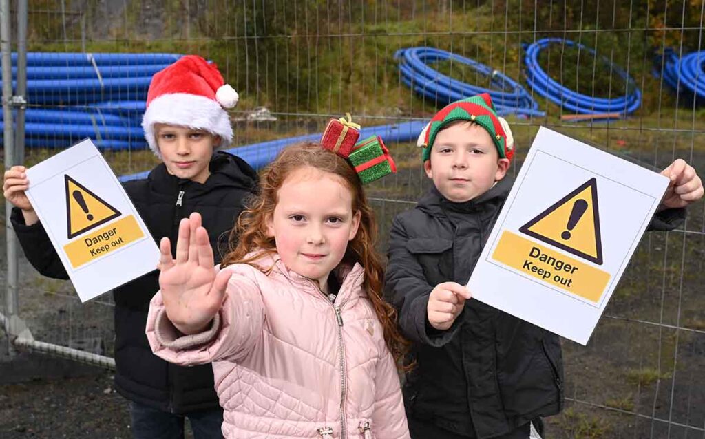 Cienna and Jace McCabe  with Jack Killen warn about the dangers of playing near waterways. 
