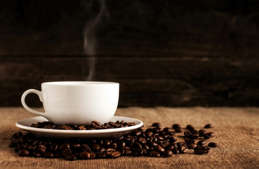 coffee cup and coffee beans on a table